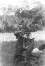 Member of US 5332nd Brigade (Provisional) John Blackburn giving fellow 5332nd member Gavin a haircut, Burma, 1945