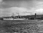 USS Honolulu in Honolulu Harbor, Hawaii, 14 Jul 1939. The Aloha Tower and an outrigger canoe can be seen at right.