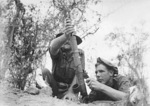 Australian Privates J. Plunkett and Private K. T. Biddle firing a 2-inch mortar, Ulunkohoitu, Australian New Guinea, 18 Jul 1945