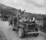 Early production Willys Jeep heavily field modified into a litter Jeep carrying wounded soldiers and medics on Saipan, Mariana Islands, Jun 1944.