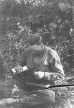 John Blackburn of US 5332nd Brigade (Provisional) cleaning his submachine gun, Burma, circa 1945