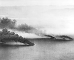 Oil tankers and transports left burning after attacks from carrier based aircraft 15 miles south of Cam Ranh Bay, French Indochina (now Vietnam), 12 Jan 1945. Photo taken from a plane from USS Hancock.