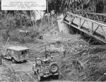 United States Army Engineers construct a “Bailey Bridge” while a WC54 ambulance and a Jeep ford the Mag-Ampon River, San Pablo, Luzon, Philippines, 3 Apr 1945. Note the machine gun mounted in the Jeep.