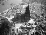 Cathedral at Cologne, Germany with the collapsed Deutz Suspension Bridge beyond, Mar 1945.