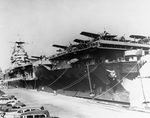 Aircraft carrier USS Hornet (Yorktown-class) at Pier 7, Norfolk Operating Base, Portsmouth, Virginia, United States, Feb 1942. Note F4F-3 Wildcats of Fighting Squadron 3 and SBC-4 Helldiver I’s from Bombing Squadron 8.