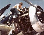 AMM1c Brannam of VF-16 working on the Pratt and Whitney R-2800 engine of a Grumman F6F-3 Hellcat fighter aboard USS Lexington (Essex-class) during a lull between strikes on Milli and Kwajalein, early Dec 1943.