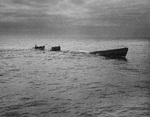 Boarding party from Coast Guard cutter Spencer approaching the U-175 after the sub was forced to the surface by depth charges, North Atlantic, 500 nautical miles WSW of Ireland, 17 Apr 1943. Minutes later, U-175 sank.