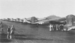 C-47 Skytrain transports loaded with paratroopers bound for the raid on Nadzab, New Guinea, 5 Sep 1943 at the Port Moresby 7-Mile Aerodrome. Note General MacArthur and General Kenney standing at the lower left.