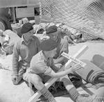 Comrades of Rifleman John Beeley of 1st King’s Royal Rifle Corps who was posthumously awarded the Victoria Cross at Battle of Sidi Rezegh on 21 Nov 1941 are working on his cross, 22 May 1942.