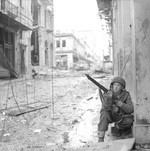 A British paratrooper with the 5th Scots Parachute Battalion takes cover in Athens, Greece during operations against ELAS (the Greek People
