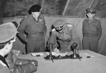 British Field Marshal Bernard Montgomery looks on as German General Eberhard Kinzel signs the documents of surrender at Montgomery’s headquarters at Lüneburg Heath, Germany, 4 May 1945.