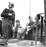 King George VI of the United Kingdom watching Field Marshal Bernard Montgomery demonstrating ground control of Typhoon aircraft from the back of a tank in the Netherlands, 12 Oct 1944.