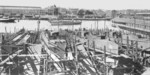 Torpedo boat slip VII, Germaniawerft yard, Kiel, Germany, circa 1920s; note downtown Kiel in background