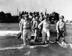General Douglas MacArthur coming ashore from an LCVP on Lingayen Gulf Blue 1 landing beach, Luzon, Philippines, 9 Jan 1945. Note Chief of Staff Lt General R.K. Sutherland beside him.