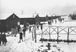 Japanese-American internees walking through the snow after leaving a Buddhist worship service at the Manzanar Relocation Center, Inyo County, California, United States, 1943.