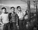 Boys at the barbed wire at the Manzanar Relocation Center for deported Japanese-Americans, 1944. This photo was taken by professional photographer, Toyo Miyatake, who was also an internee.