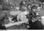 Personnel of the German Grossdeutschland brigade showing a Panzerschreck weapon to a child from a village near the location of their field exercise, Germany, Oct 1944