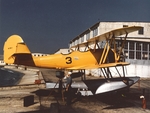 N3N-1 Canary trainer (Bureau Number 0265) on a seaplane ramp, Naval Air Station Pensacola, Florida, United States, 1942; note N3N-2 rudder and removed panels near engine