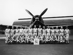 Members of United States Navy Bombing Squadron 87 standing in front of a Curtiss SB2C Helldiver at Kahului Naval Air Station, Maui, Hawaii, Apr 1945.