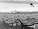 As seen from the USS Hornet (Essex-class) anti-aircraft shells burst above the USS Bennington southeast of Kyushu, Japan, 14 May 1945. Note Hornet’s F6F Hellcats in the foreground.
