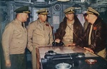 Commander Task Force 77, Rear Admiral J.J. Clark, second from left, and other task force commanders listening to Commander 7th Fleet, Vice Admiral Robert Briscoe, right, during the Korean War, 1952.
