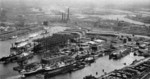 View of Howaldtswerke Kiel shipyard, Kiel, Germany, 1939; note slips, floating dry docks, equipping piers, and workshops; Schwentine River at right center