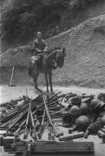 Mounted Chinese officer with captured Japanese equipment, Hubei Province, China, 1942, photo 2 of 2; note Arisaka Type 38 rifles, Type 96 machine gun, and other unidentified equipment