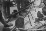 Captured Japanese Type 11 (background), Type 96 (center rear), Type 11 (center front), and DP (foreground with pan) machine guns, Hubei Province, China, 1942; note stocks of Arisaka Type 38 rifles and helmets