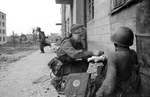 Yevgenia Lavretyevna Soltanovskaya of Soviet 14th Tank Brigade bandaging the hand of a soldier, Voronezh, Russia, Jul 1942