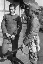 Chinese soldier with Hangyang Type 88 rifle guarding a Japanese prisoner of war, Changde, Hunan Province, China, 25 Dec 1943