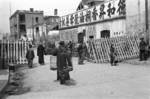 Civilians walking pasting a road block being readied in preparation of a possible Japanese invasion, Chongqing, China, fall of 1937