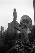 Harrison Forman in a ruined section of Chongqing, China, 1942, photo 1 of 4