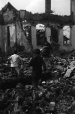 Children playing amongst destroyed buildings, Chongqing, China, 1941