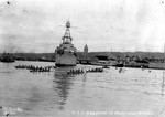 Cruiser USS Houston carrying President Franklin Roosevelt arriving in Honolulu Harbor, Hawaii, 26 Jul 1934. Notice numerous traditional Hawaiian small boats and the Aloha Tower in the background.