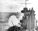 Cruiser USS Northampton firing her 8-inch guns in a bombardment of Wotje in the Marshall Islands, 1 Feb 1942. Note cruiser Salt Lake City in the background. Page 1 of 2.