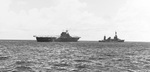 Destroyer USS Russell coming alongside the stricken USS Hornet (Yorktown-class) with cruiser USS Northampton standing off (right), Battle of Santa Cruz Islands, 26 Oct 1942. Photo 1 of 2.