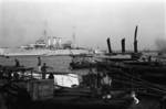 Chinese workers on a pier, Shanghai, China, mid-1937, photo 4 of 5; note HMS Cumberland in background