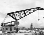 Floating crane YD-82 at Pearl Harbor, Hawaii, 1943-44 (Berth B-25, Merry Loch). Note the harbor ferry Nihoa at right with a load of sailors in liberty whites. Note also fleet headquarters building in camouflage paint.