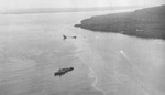 Minelayer USS Breese standing by as a motor launch tows the wreck of the destroyer USS Tucker toward shallow water off Malo Island after Tucker was nearly blown in two by a mine the day before, 4 Aug 1942.