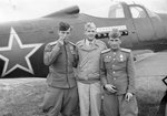 Soviet pilots Andrea Hincerockur and Corzen Venzopkin flank United States Army Lieutenant Thompson Highfill of the 99th Bomb Group in front of a Soviet P-39 Airacobra, Poltava Air Base, Ukraine, 21 Jun 1944.