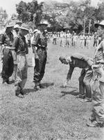 Japanese Maj. General Michio Uno of the 37th Army lays down his sword at the feet of Australian Army Lt Colonel Ewan Murray Robson at Bandjermasin, Borneo, 17 Sep 1945.