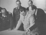 Ernst Udet, Karl Bodenschatz, Hermann Göring, and Wilhelm Messerschmitt reviewing blueprints at a Messerschmitt factory, 20 Feb 1941