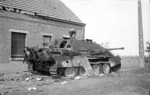 British soldier examining a Jagdpanther S.P. Tank Destroyer knocked out by a M4 Sherman tank near Gheel, Belgium, 13 Sep 1944.
