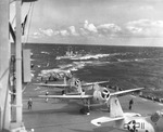 3 TBM-1C Avengers and 2 FM-2 Wildcats of Composite Squadron 69 readying for take-off from escort carrier USS Mission Bay on an anti-submarine patrol in the Atlantic, spring 1945.