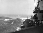 Heavy seas of Typhoon Connie as seen from the cruiser USS Pittsburgh looking aft down her starboard side, dawn 5 Jun 1945 in the Philippine Sea. Pittsburgh lost 110-feet of her bow in this storm.