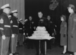 Lieutenant General Clifton Cates cutting a cake during the celebration of the anniversary of the establishment of the US Marine Corps, Quantico, Virginia, United States, 10 Nov 1953, photo 1 of 2; Brigaider General Robert Bare and Major General Edwin Pollock in background