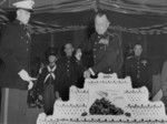 Lieutenant General Clifton Cates cutting a cake during the celebration of the anniversary of the establishment of the US Marine Corps, Quantico, Virginia, United States, 10 Nov 1953, photo 2 of 2; Brigaider General Robert Bare and Major General Edwin Pollock in background