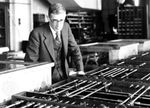 Vannevar Bush standing over a section of his differential analyzer at the Massachusetts Institute of Technology, circa 1935.
