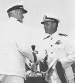 Admiral Chester Nimitz presenting the Presidential Unit Citation pennant to USS Bowfin commanding officer Commander John Corbus at Pearl Harbor, Hawaii, Jul 1944.
