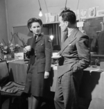 Actress Muriel Pavlow, in WAAF uniform, talking with casting director Bob Lennard at the Globe Theatre (now Gielgud Theatre), London, England, United Kingdom, 1945